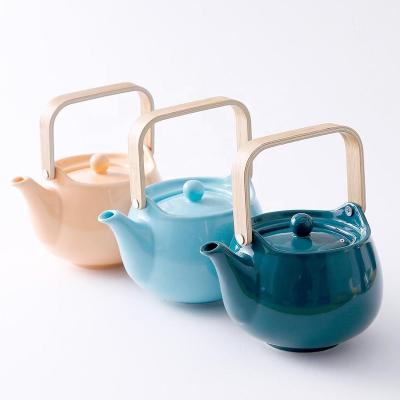 China Viable loose tea set high quality solid color cheap ceramic teapot with bamboo lid and strainer for sale