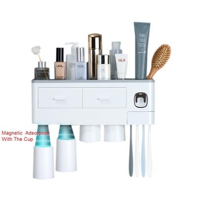 China Wall Mounted Multifunctional Automatic Magnetic Toothbrush Toothpaste Squeezer Squeezer Storage Holder Viable Adsorption for sale