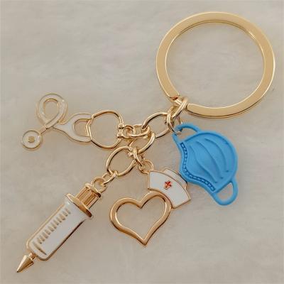 China Cheap Souvenir Gift Factory Price Running Cute Nurse Medical Needle Holder Circle Key Chain with Thermometer and Magnifying Key Chain for sale