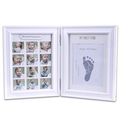 China Home decoration folding safety and environmental protection baby cute commemorative creative hand and foot printed photo solid wood frame for sale