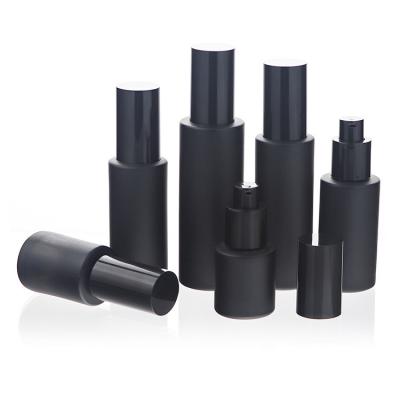 China Luxury Glass Set 30ml Matte Black Cosmetic Packaging Serum Bottle Essential Oil Lotion Bottle for sale