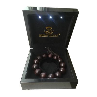 China Handmade Luxury Black Polish MDF Jewelry Wedding Ring Lamp Bracelet Piano Painting Wooden Jewelry Box With LED Light for sale