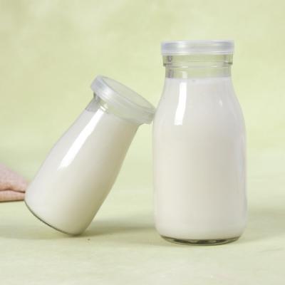 China Beverage Vintage Milk Bottle Shaped 100ml 200ML Corked Glass Bottles for sale