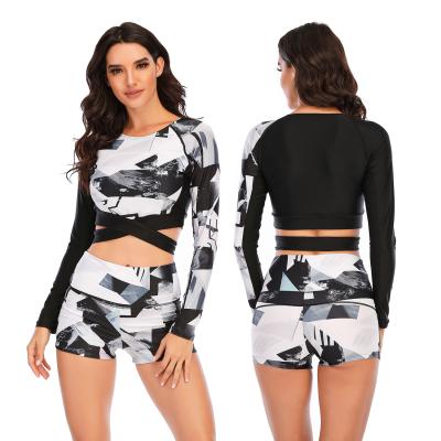 China Windproof Two-Piece Color Printed Long Sleeve Tan Crisscross Crop Top Swimsuit for sale