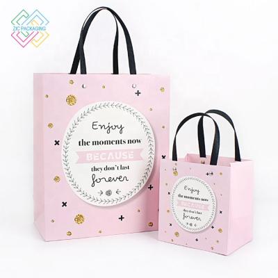 China Custom Recycled Materials Logo Biodegradable Christmas Paper Gift Bag Wedding Paper Gift Bag With Ribbon Handle for sale