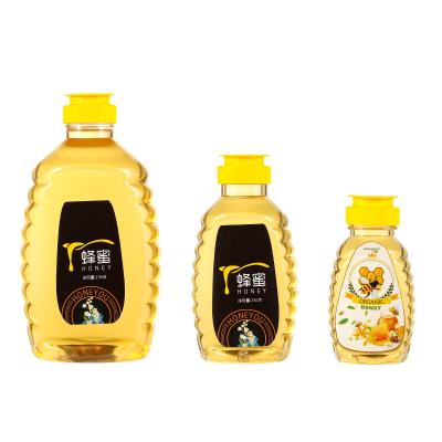 China Food Factory Directly Selling Transparent Honey Packaging Bottle With Flip Top Cap For Honey for sale