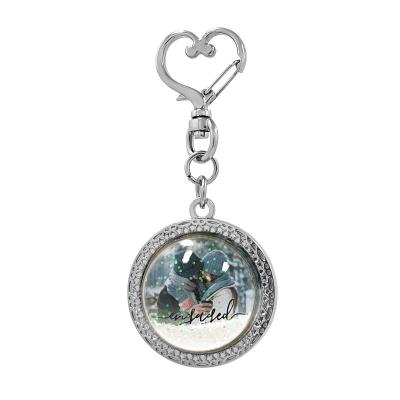 China Wholesale Metal Promotional Souvenir Glitter Quicksand Snow Globe Floating Keychain for sale