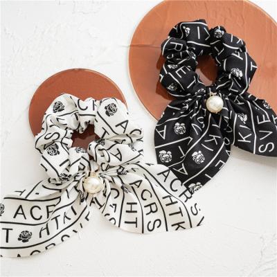 China Personalized Pearl Dangle Bow Head Elastic Scrunchies Black And White Letter Scarf Pony Friendly Materials for sale