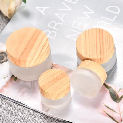 China 30ml 50ml 100ml 120ml 150ml 200ml Cosmetic Amber Body Butter Clear Frosted Plastic Jar With Bamboo Wooden Lid for sale