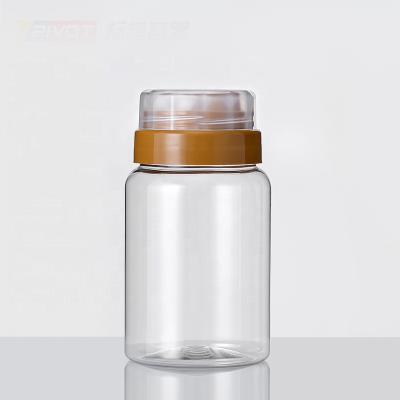 China Popular 300g500g1000g Honey Bottles Jar Food Grade Plastic With Cap Cover And Double Cap Layer For Easy Pull Back Port for sale