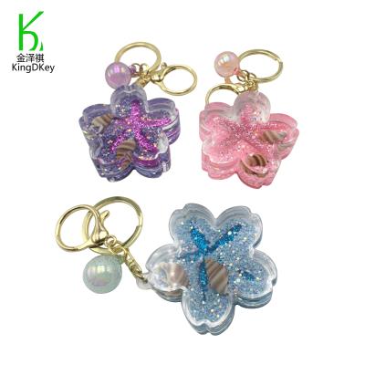 China Creative Key Chain Cherry Blossom Shaped Acrylic Starfish Pendant Shell Sequins Decoration Moving Liquid Plastic Quicksand for sale