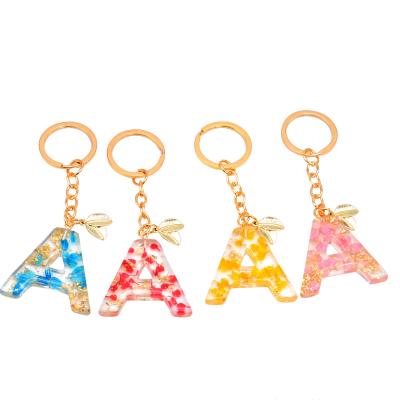 China Decoration gift wholesales high quality dry flower petals English letters keychains flower key chain for sale