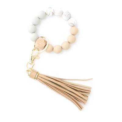 China Bohemia Silicone Beads Wooden Beaded Key Ring Leather Tassel Bracelets Keychains Beech Wrist Bracelet for Women for sale