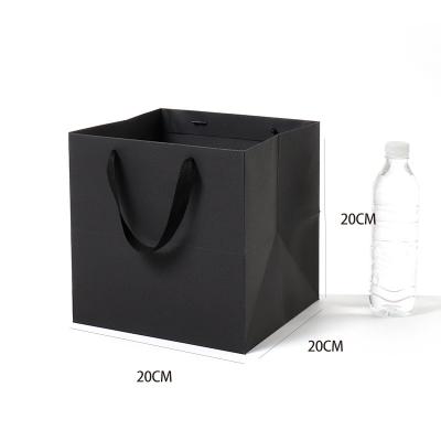 China Recyclable Wholesale Custom Logo Paper Shopping Carrier Bag Customized Black White Gift Packaging Bag for sale