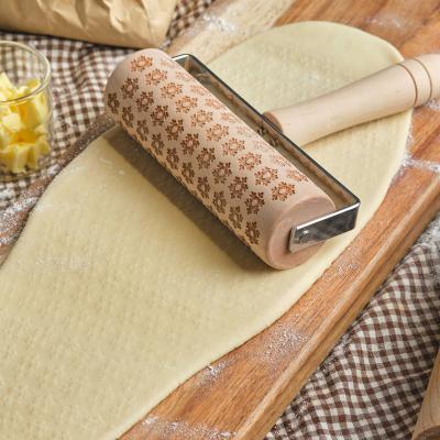 China Sustainable Christmas embossed rolling pin household solid wood T-shaped snowflake Rolling pin dedicated to cookies for sale