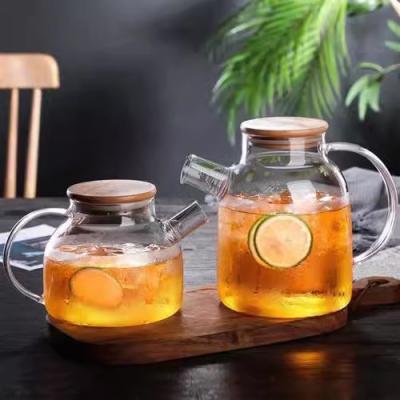 China Sustainable Hot sale clear glass water jug high borosilicate heat resistant glass teapot with bamboo Lid for sale