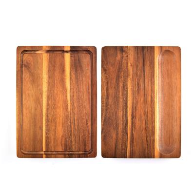 China Sustainable Amazon Acacia Wood Kitchen Cutting Board With Nice Grooves And Compartment for sale