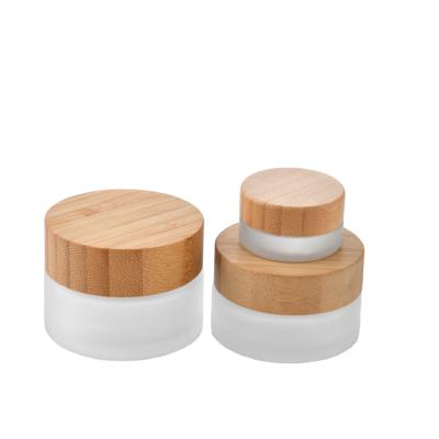 China 50ml White Empty Cosmetic Glass Cream Bottle Skin Care Bamboo Lid Cream Jar Bamboo Glass Jar for sale