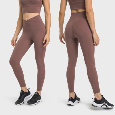 China Breathable Cross Waist Sports Tights Women's Double Side Pockets No T Line Running Fitness Yoga Leggings for sale