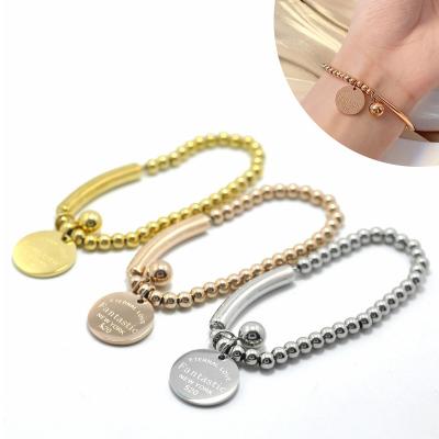 China FASHIONABLE Luxury Gold Plated Stainless Steel Pipe Ball Bracelet Engraved Name Bead Stackable Bracelet With Circle Charm Tag for sale