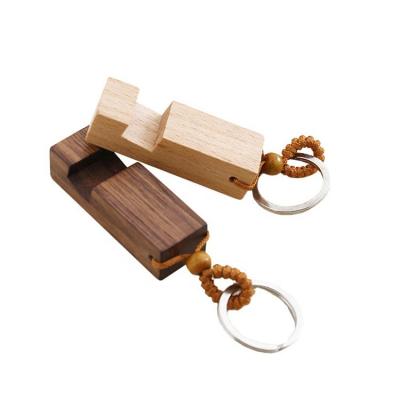 China Eco-friendly Natural Wood Phone Holder Stand Key Chain Car Keychain Pendant Accessories 2 in 1 Wooden Keychains for sale