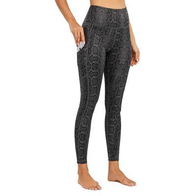 Chine Pantalon étirable piquant de yoga de guêtres de séance d'entraînement d'impression de peau de serpent d'OEM Flatlock à vendre