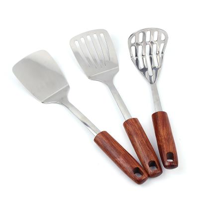 China Manufacturer Stocked Custom Kitchen Accessories Stocked Stainless Kitchen Utensils Turner With Wood Handle for sale