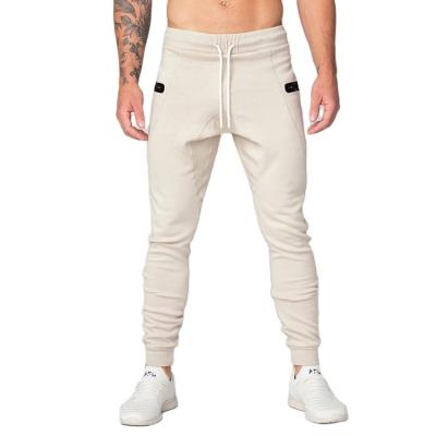 China Wholesale Mens Sportswear Breathable Track Pants Zipper Pockets Gym Workout Mens Stretchy Fitted Joggers for sale