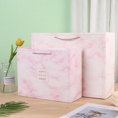 China Recyclable High Standard Stylish Bulk Shopping Paper Bag With Ribbon Handle for sale