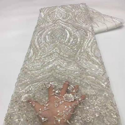 China Viable hot style high quality dry lace wedding lady dress beads the latest luxury lace fabric for sale