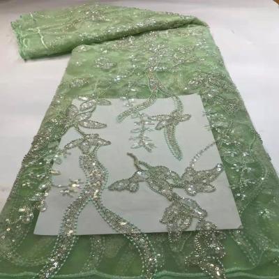 China 2020 Viable New Design Flower Leaf Embroidered Net Tulle Sequin Gold Lace Fabric for sale