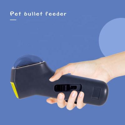 China Automatic Stocked Pet Bullet Feeder Supplies Toy Food Treat Gun Dispenser Launcher for sale