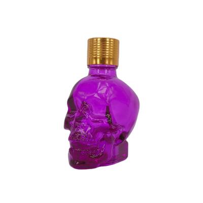 China Stocked Dropper Bottles Glass Pink Glass Bottle Customized Skull Shaped Serum Bottles for sale