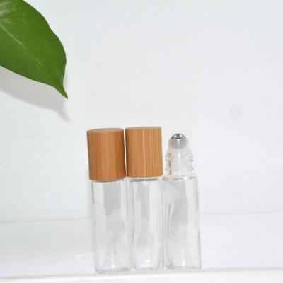 China Essential Oil Cosmetic Luxury Glass Roll On Roll Bottle 10ml For Cosmetics And Perfume With Bamboo And Wooden Lid for sale