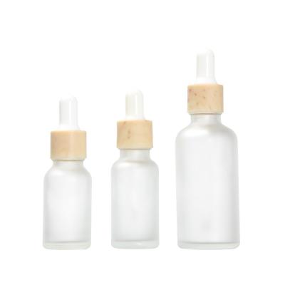 China 15ml 20ml 30ml 50ml Cosmetic Grain Wood Ring Tip Dropper Essence Essence Transparent Frosted Rubber Oil Bottle for sale