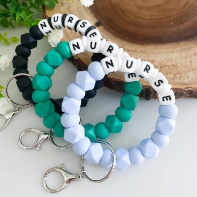 China Fashion Personalized Solid Color Silicone Bead Key Bracelet Chain For Nurse Nurses Day Caregiver Gift Letter Bracelet Key Ring for sale