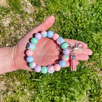 China Cute Fashion Link Dye Pastel Silicone Beaded Bracelet Key Chain With Suede Leather Tassel For Women Gift Key Holder Fashion Bag Pendant for sale