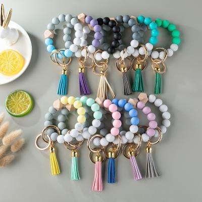 China Wholesale Fashion Candy Color Colorful Silicone Beads Elastic Wristband Bracelet Key Chain With Suede Tassel Car Bag Women Leather Key Ring for sale