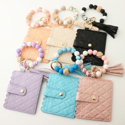 China 2022 New Fashionable Cowhide Floral Printing Silicone Wristband Women's Key Chain Bracelet Tassel Rhombus Leather Beaded Credit Card Wallet for sale