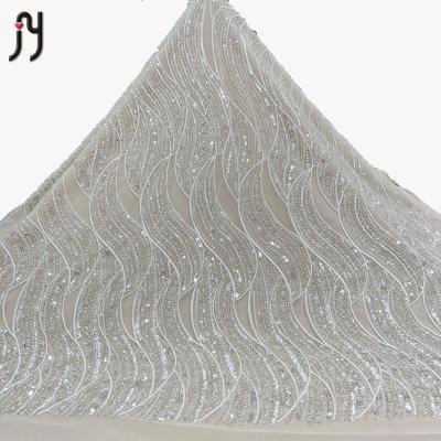 China Viable high quality white voile net beaded bridal lace fabric and 3-5mm sequin embroidery crystal fabric for wedding dresses white for sale