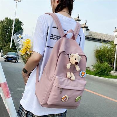 China Student Solid Color Waterproof School Bags for Girls Nylon Backpacks for Women Cute Bear Schoolbag for sale