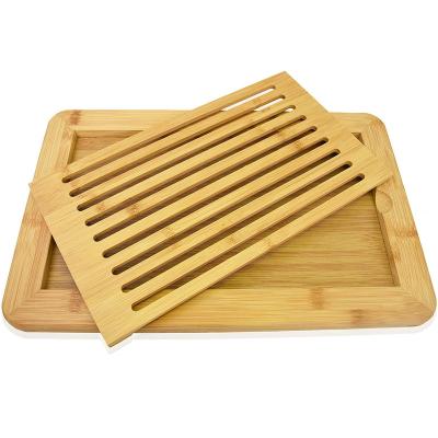 China Sustainable Organic Bamboo Slotted Bread Cutting Board With Removable Crumb Catcher for sale