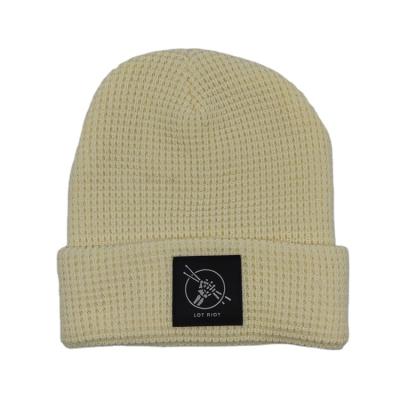 China Custom Acrylic Woven Label COMMON Logo Knitted Winter Hat Slouchy Slapped Beanie for sale