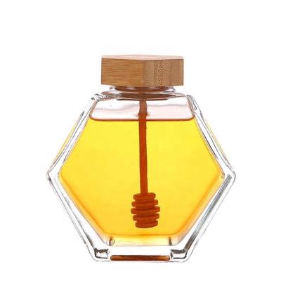 China Wholesale 100ml Honey Glass Bottle Storage Eco-friendly Hexagonal Glass Honey Jar With Wooden Lid for sale