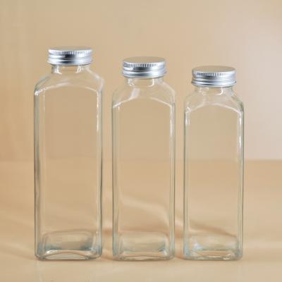 China Wholesale Empty Beverage Glass Bottles 300ml 350ml 480ml Beverage Glass Bottles With Screw Lid for sale