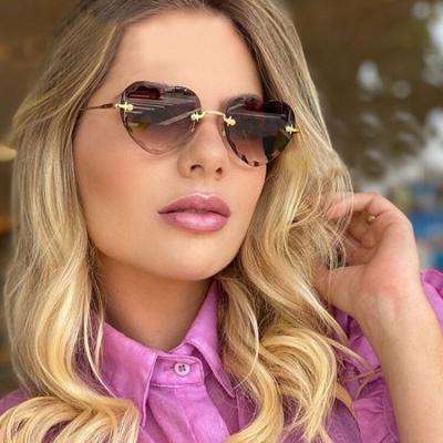 China Fashion Sunglasses Shape Wave Frame New Rimless Heart Shape Sunglasses Newcomers Colored Ocean Glass UV400 Sun Glasses for sale