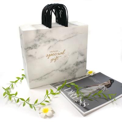 China Recyclable Marble White Packaging Clothes Reusable Logo Printed Kraft Paper Shopping Bag For Boutique With Black Paper String Handle for sale