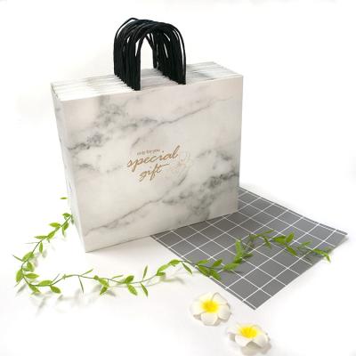 China Recyclable Custom Paper Bags Gold Marble Boutique Store Gift Paper Shopping Bags With Special Gift for sale