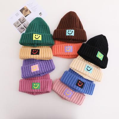 China IDS Fashion Winter Autumn Children Headwear Hat Smile Pattern Knitted Baby Boy Soft Warm Hat for sale