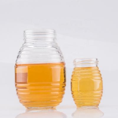 China 350ml Glass Jar Embossed by Honey High Quality Empty Texture Honey Jar Unique Hot Sale for Honey Sauce for sale